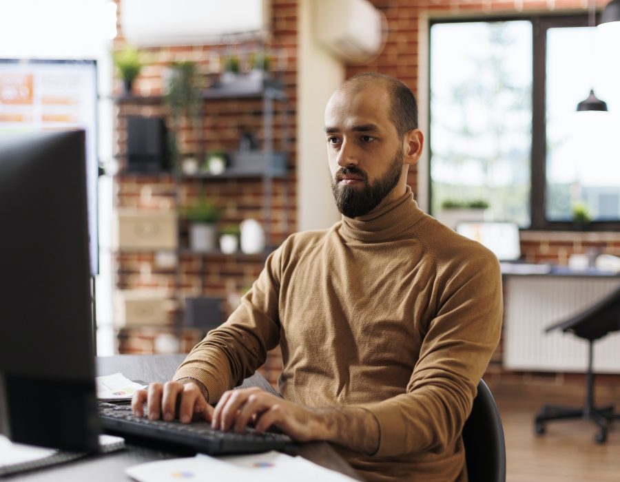 Confident project manager working on business strategy and financial analysis while sitting company